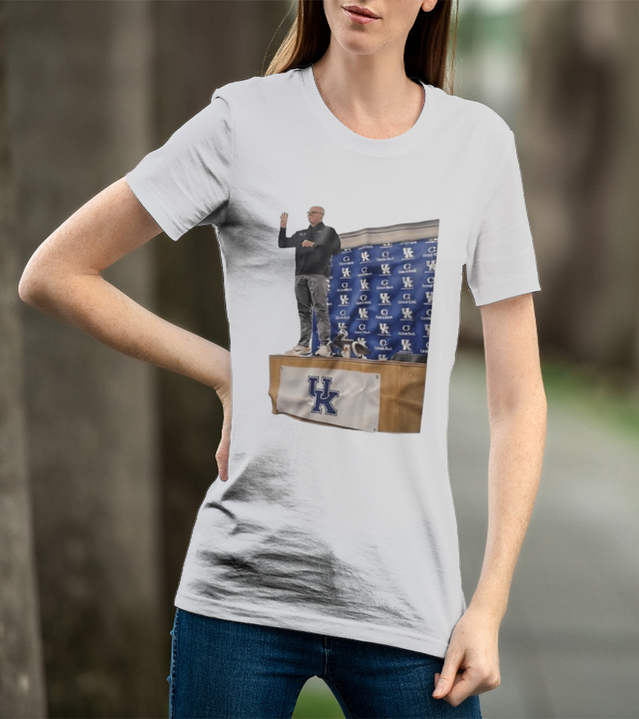 UK Volleyball Coach Craig Skinner Standing On Table With UK Logo And Awards T-Shirt
