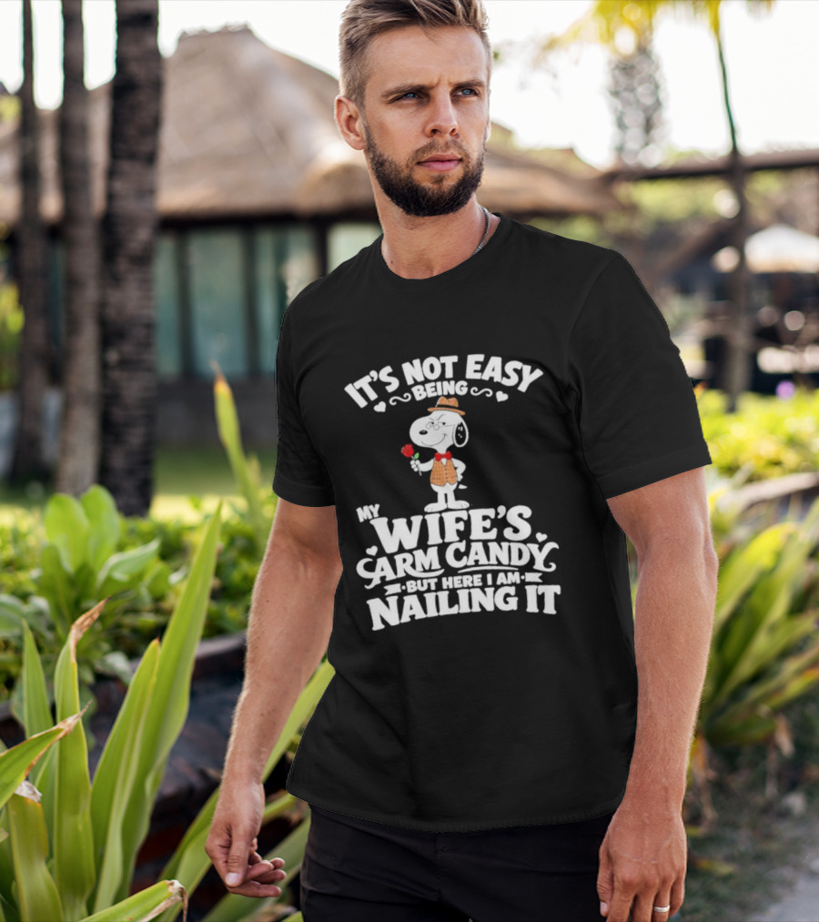 Snoopy It's Not Easy Being My Wife's Arm Candy But Here I Am Nailing It T-Shirt